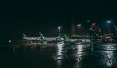 three white and green plane on the airport photography during nighttime