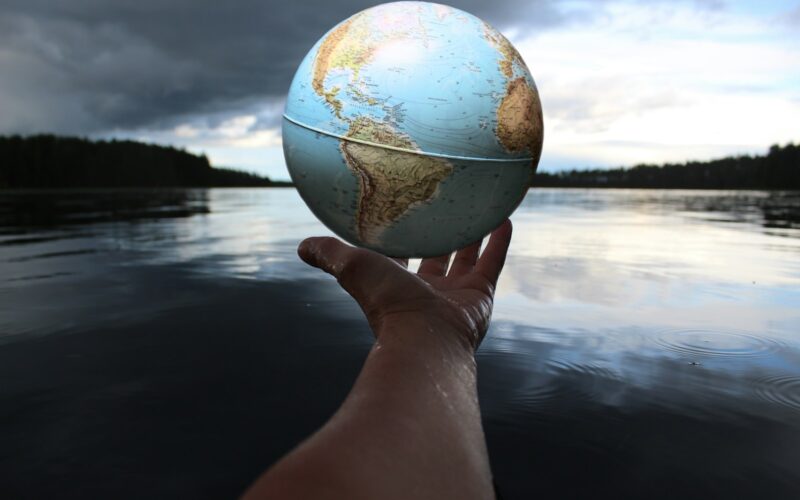 person holding clear glass ball